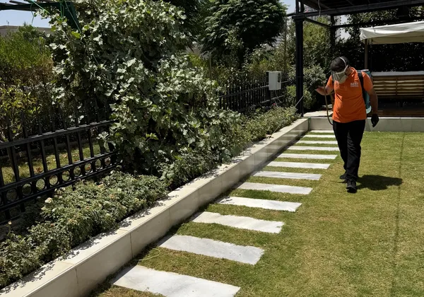 Best Control technician treating an outdoor garden area in Erbil