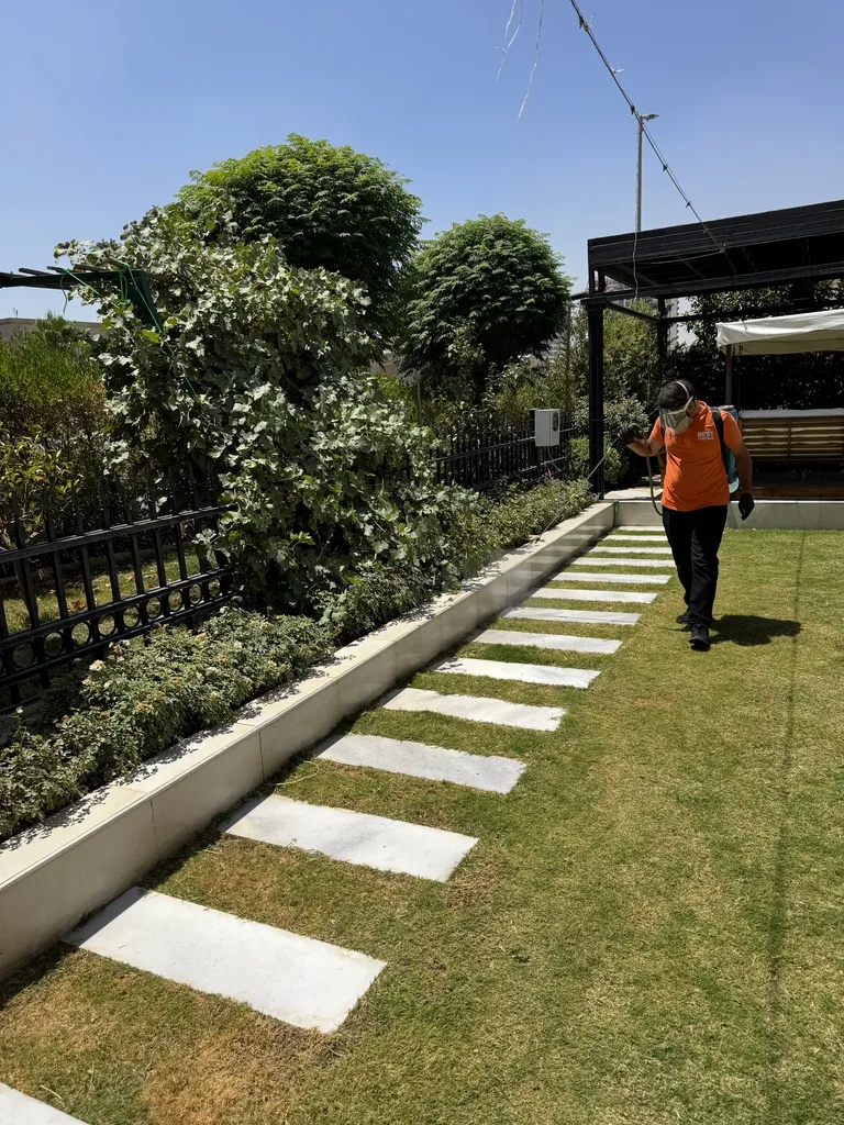 Best Control technician treating an outdoor garden area in Erbil